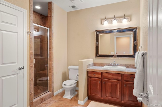 bathroom with vanity, tile patterned flooring, a shower with door, and toilet