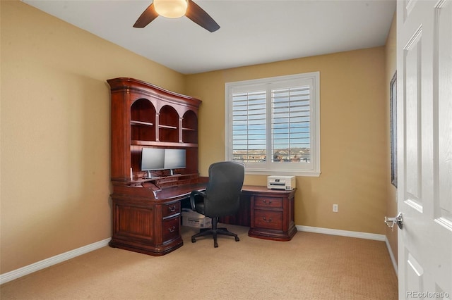 carpeted office space with ceiling fan