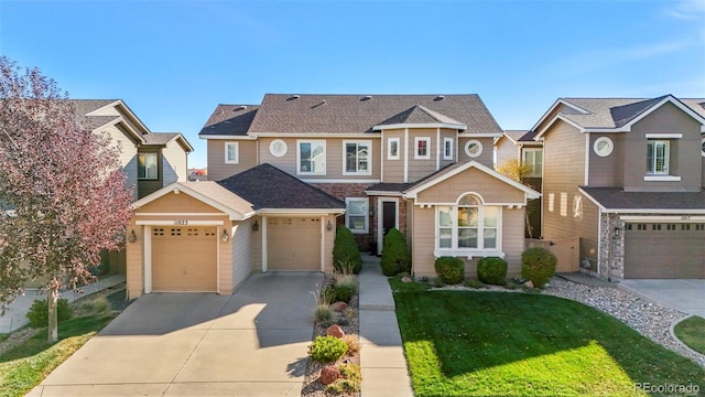 view of front of house featuring a garage and a front lawn