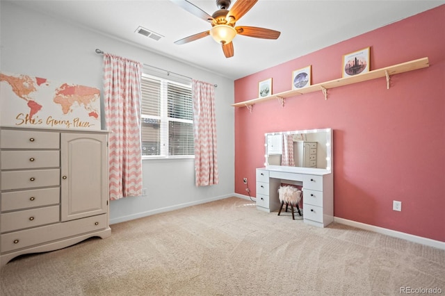 unfurnished bedroom featuring a ceiling fan, visible vents, light carpet, and baseboards