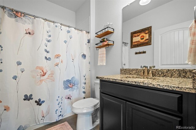 full bathroom with vanity and toilet