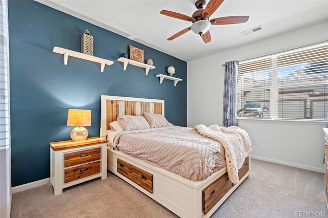 bedroom with light colored carpet, visible vents, ceiling fan, and baseboards