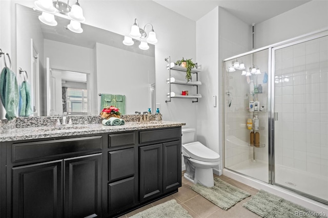 full bath featuring a sink, a shower stall, an inviting chandelier, and tile patterned floors