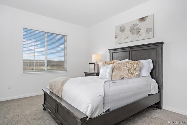 bedroom featuring baseboards and light carpet