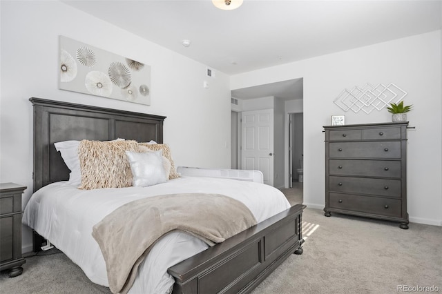 bedroom with visible vents, light colored carpet, and baseboards