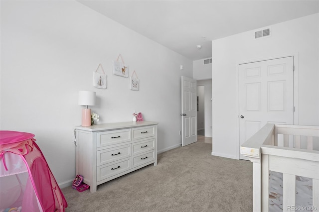 bedroom with visible vents, light carpet, and baseboards