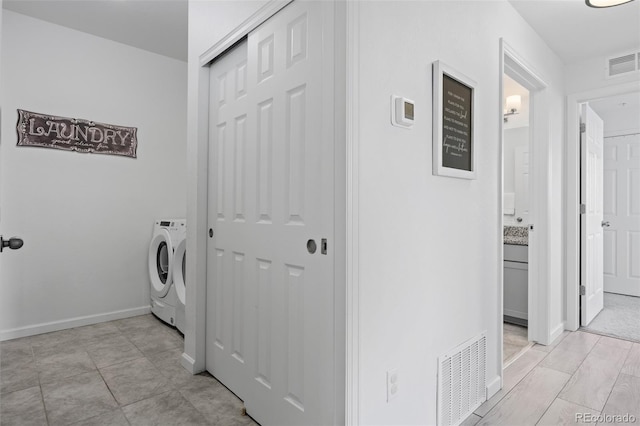 laundry room with laundry area, washer and dryer, baseboards, and visible vents