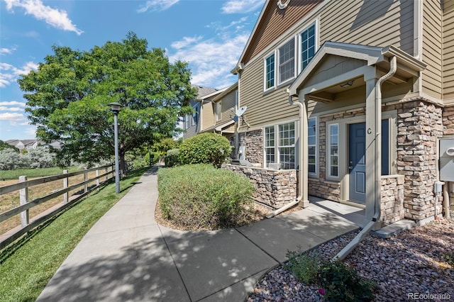 12753 Leyden St Unit C, Thornton, CO 80602 - view of side of home featuring stone siding