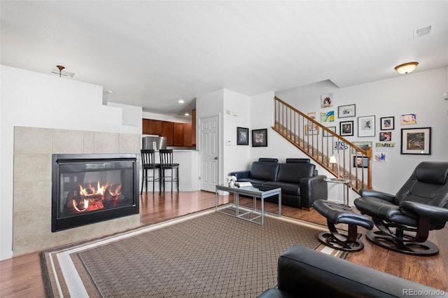 12753 Leyden St Unit C, Thornton, CO 80602 - living area featuring wood finished floors, stairway, and a fireplace