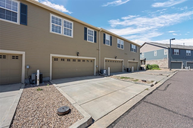 12753 Leyden St Unit C, Thornton, CO 80602 - view of front facade featuring an attached garage, driveway, and a residential view
