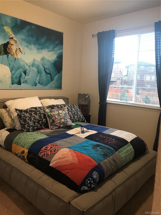 bedroom featuring carpet flooring and multiple windows