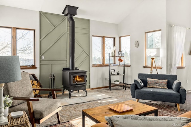 living room featuring vaulted ceiling and a wood stove