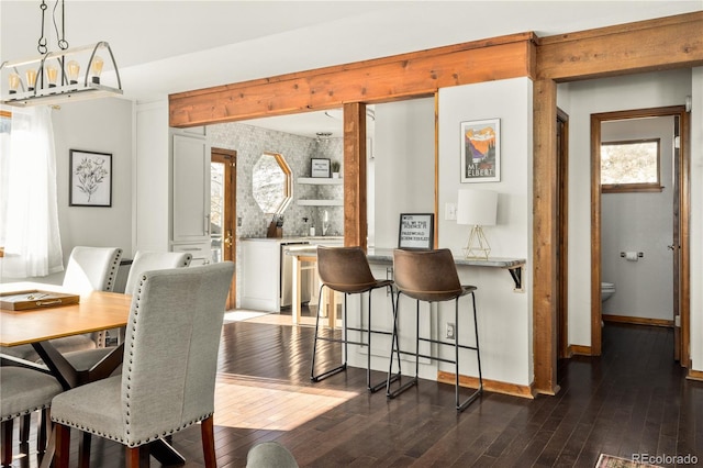 dining space featuring a notable chandelier and dark hardwood / wood-style flooring