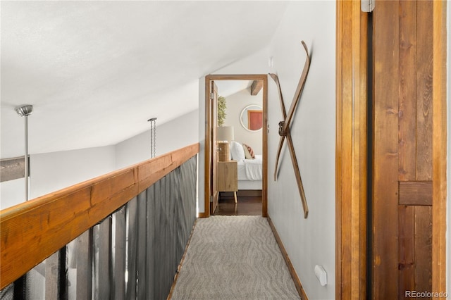 corridor featuring light colored carpet and vaulted ceiling