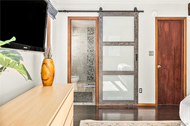 doorway to outside with a barn door and hardwood / wood-style floors