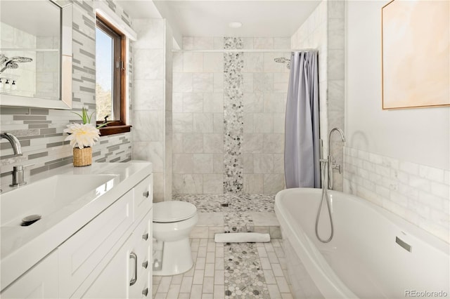 full bathroom featuring toilet, shower with separate bathtub, tile walls, vanity, and tile patterned flooring