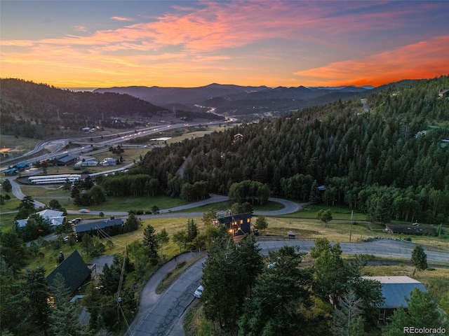 aerial view at dusk featuring a mountain view