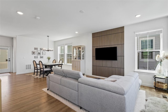 175 Westerly Blvd, Erie, CO 80516 - living room with a chandelier, wood finished floors, and recessed lighting