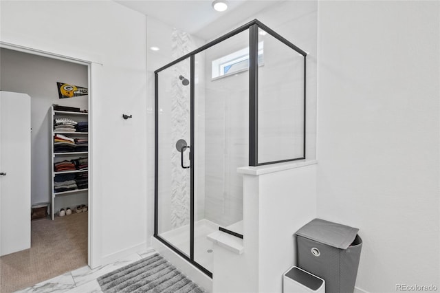 175 Westerly Blvd, Erie, CO 80516 - full bathroom featuring a stall shower, a walk in closet, and marble look tile flooring