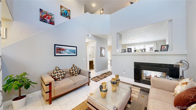 19730 E 58th Pl, Aurora, CO 80019 - living area with baseboards and a multi sided fireplace
