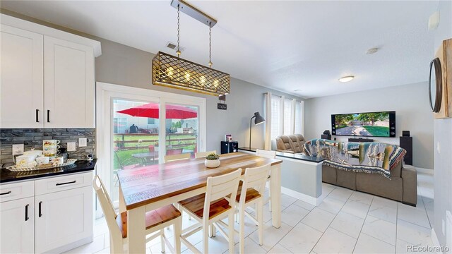 19730 E 58th Pl, Aurora, CO 80019 - dining space featuring light marble finish floors and baseboards