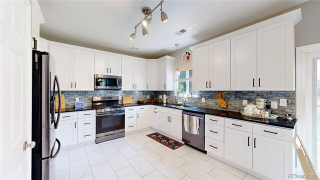 19730 E 58th Pl, Aurora, CO 80019 - kitchen featuring appliances with stainless steel finishes, dark countertops, tasteful backsplash, and white cabinets