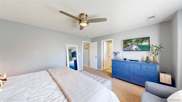 19730 E 58th Pl, Aurora, CO 80019 - bedroom featuring light colored carpet, a ceiling fan, a textured ceiling, baseboards, and ensuite bath