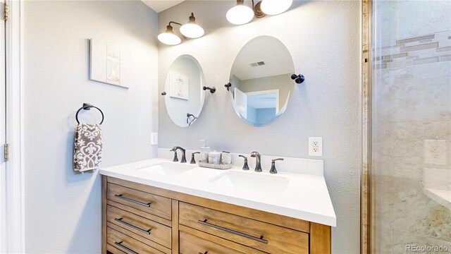 19730 E 58th Pl, Aurora, CO 80019 - full bathroom featuring double vanity and tiled shower