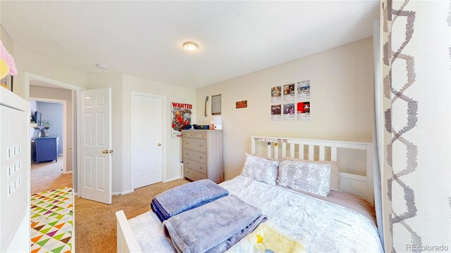 19730 E 58th Pl, Aurora, CO 80019 - bedroom with light carpet, a closet, and baseboards