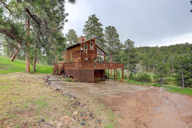 13190 Coyote Song Trl, Conifer, CO 80433 - view of outbuilding featuring dirt driveway, a view of trees, and stairway
