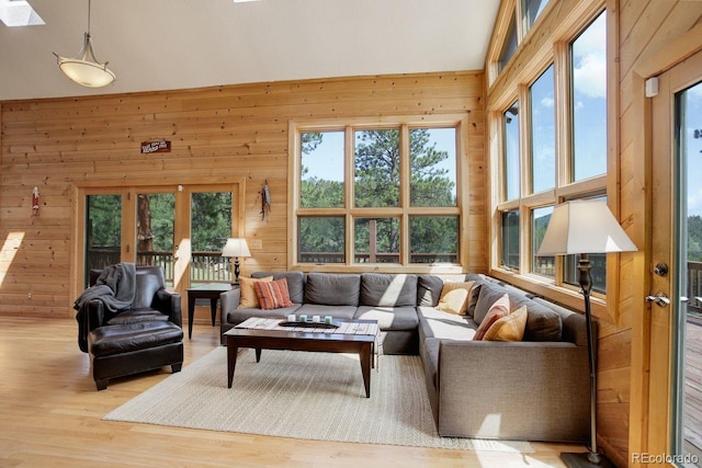 13190 Coyote Song Trl, Conifer, CO 80433 - living area with healthy amount of natural light, wood walls, and wood finished floors