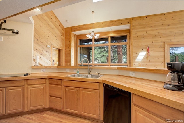 13190 Coyote Song Trl, Conifer, CO 80433 - kitchen featuring black appliances, a sink, butcher block countertops, wood walls, and light wood-style floors