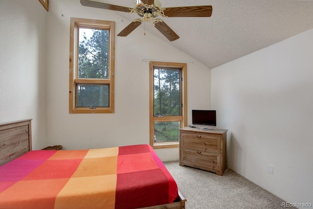 13190 Coyote Song Trl, Conifer, CO 80433 - bedroom with light carpet, vaulted ceiling, a textured ceiling, and ceiling fan