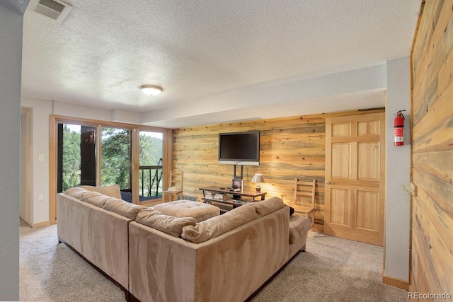 13190 Coyote Song Trl, Conifer, CO 80433 - living area with wood walls, light colored carpet, and a textured ceiling