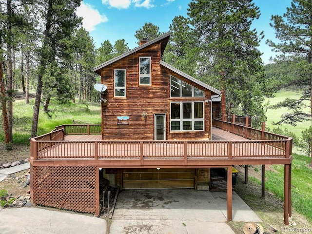 13190 Coyote Song Trl, Conifer, CO 80433 - rear view of house featuring a deck and driveway