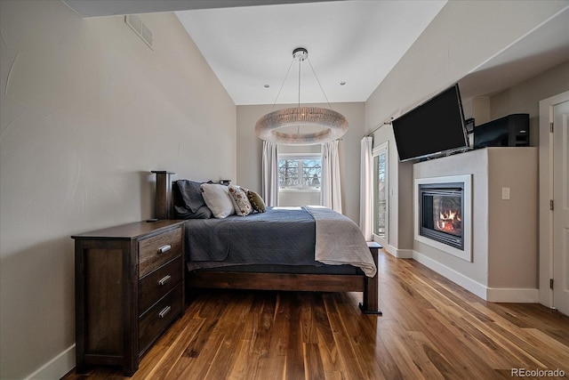 bedroom with dark hardwood / wood-style flooring