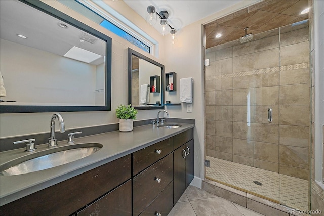 bathroom featuring tile patterned flooring, vanity, and a shower with shower door