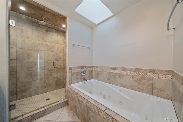 bathroom with tile patterned flooring, a skylight, and shower with separate bathtub