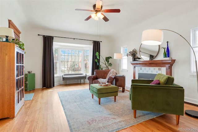 living area featuring ceiling fan and light hardwood / wood-style flooring