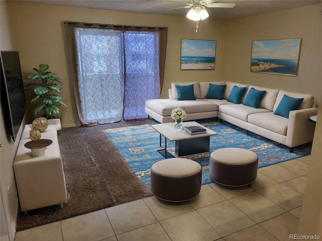 living area with tile patterned flooring, a textured ceiling, and a ceiling fan