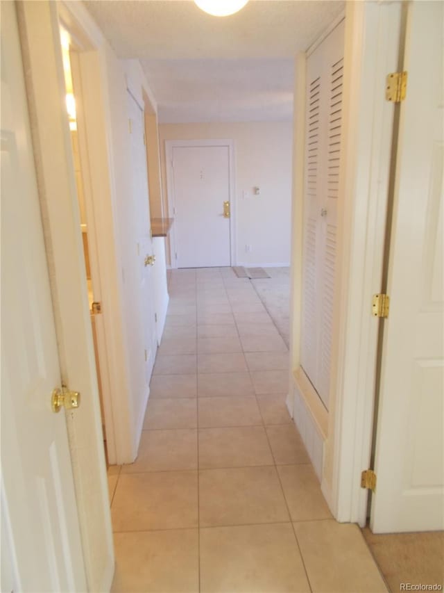 hall featuring light tile patterned floors