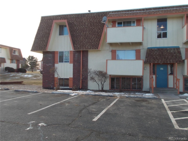 view of building exterior with uncovered parking