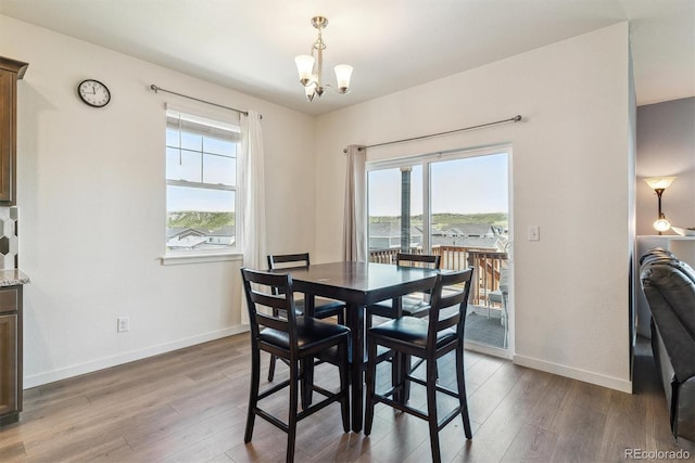 4992 Trails Edge Ln, Castle Rock, CO 80104 - dining room featuring wood finished floors, baseboards, and a chandelier