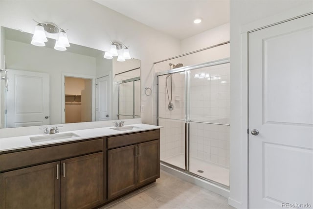 4992 Trails Edge Ln, Castle Rock, CO 80104 - full bath with a shower stall, double vanity, a walk in closet, and tile patterned floors