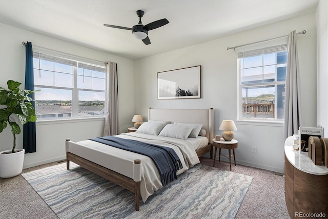 4992 Trails Edge Ln, Castle Rock, CO 80104 - carpeted bedroom featuring multiple windows, baseboards, and a ceiling fan