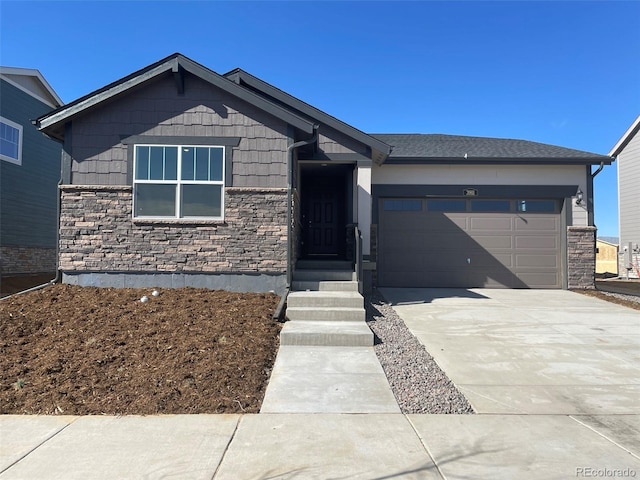 ranch-style house featuring a garage, driveway, and stone siding