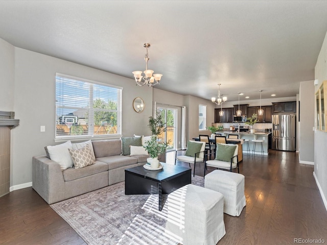 living room with dark hardwood / wood-style flooring and a chandelier