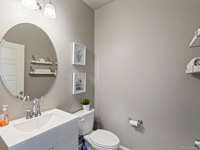 bathroom with toilet and vanity