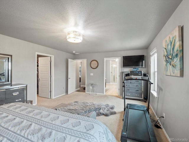 bedroom with a textured ceiling and light carpet