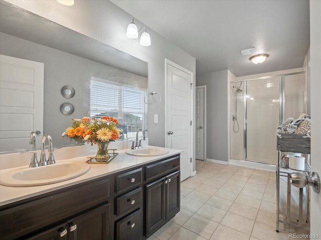 bathroom with tile patterned flooring, a shower with shower door, and vanity